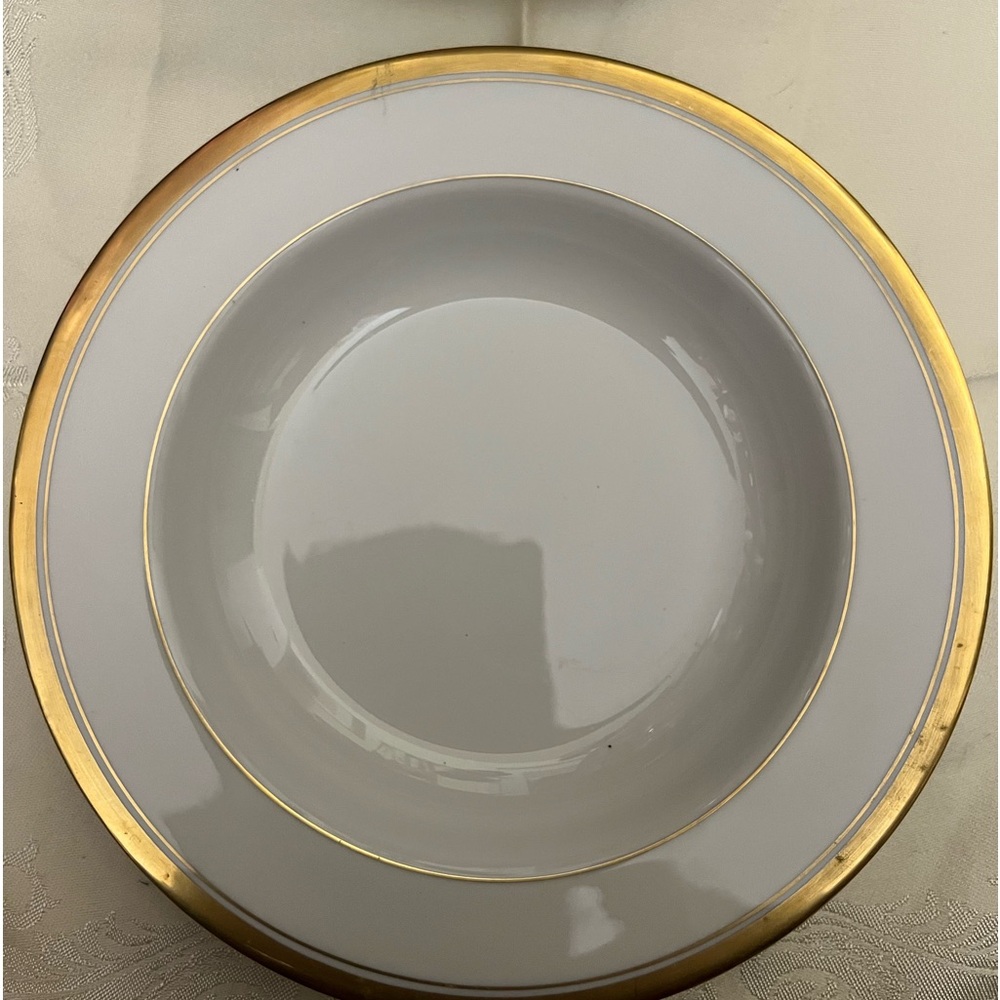 Used . KIRK salad deep plate. 8” diameter 1.4” deep.  Color cream and Gold trim.